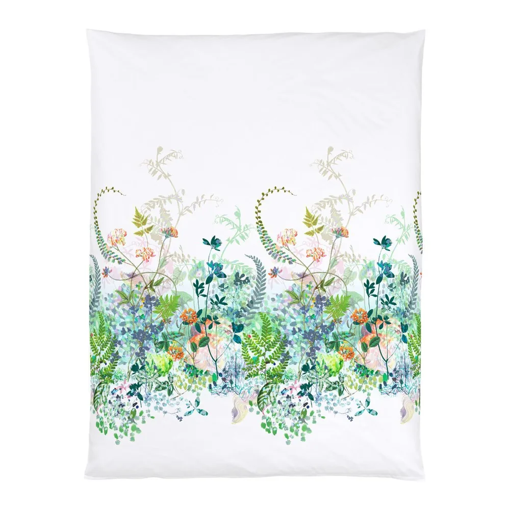 A white pillow is sitting on a white surface.