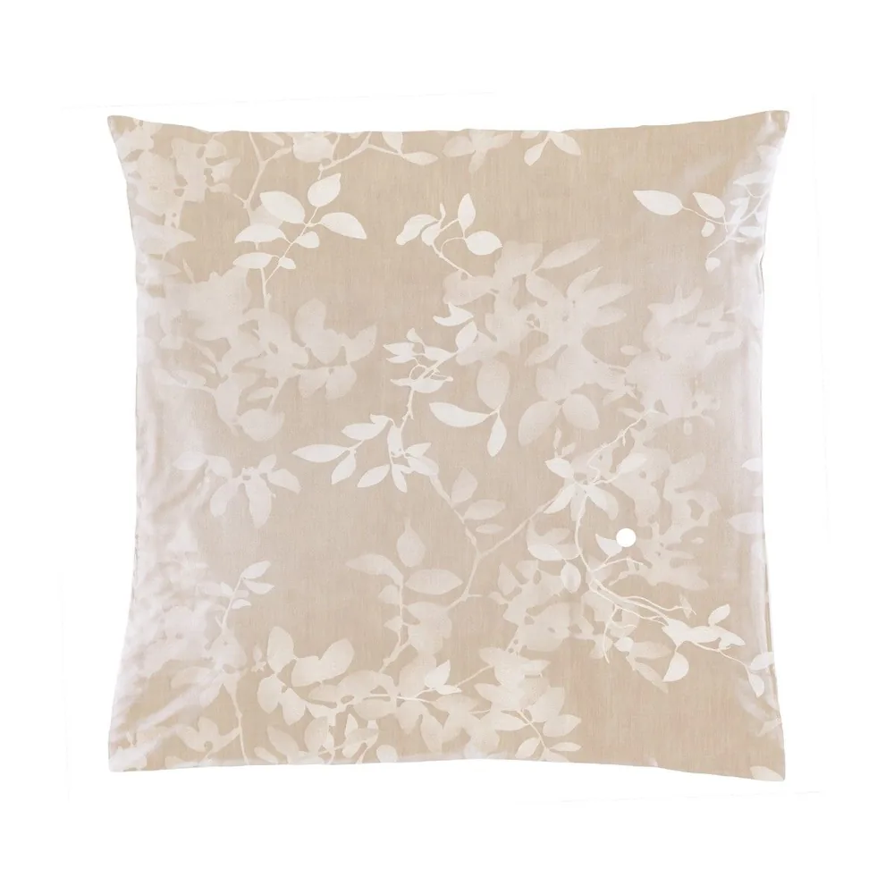 A white pillow is sitting on a white surface.