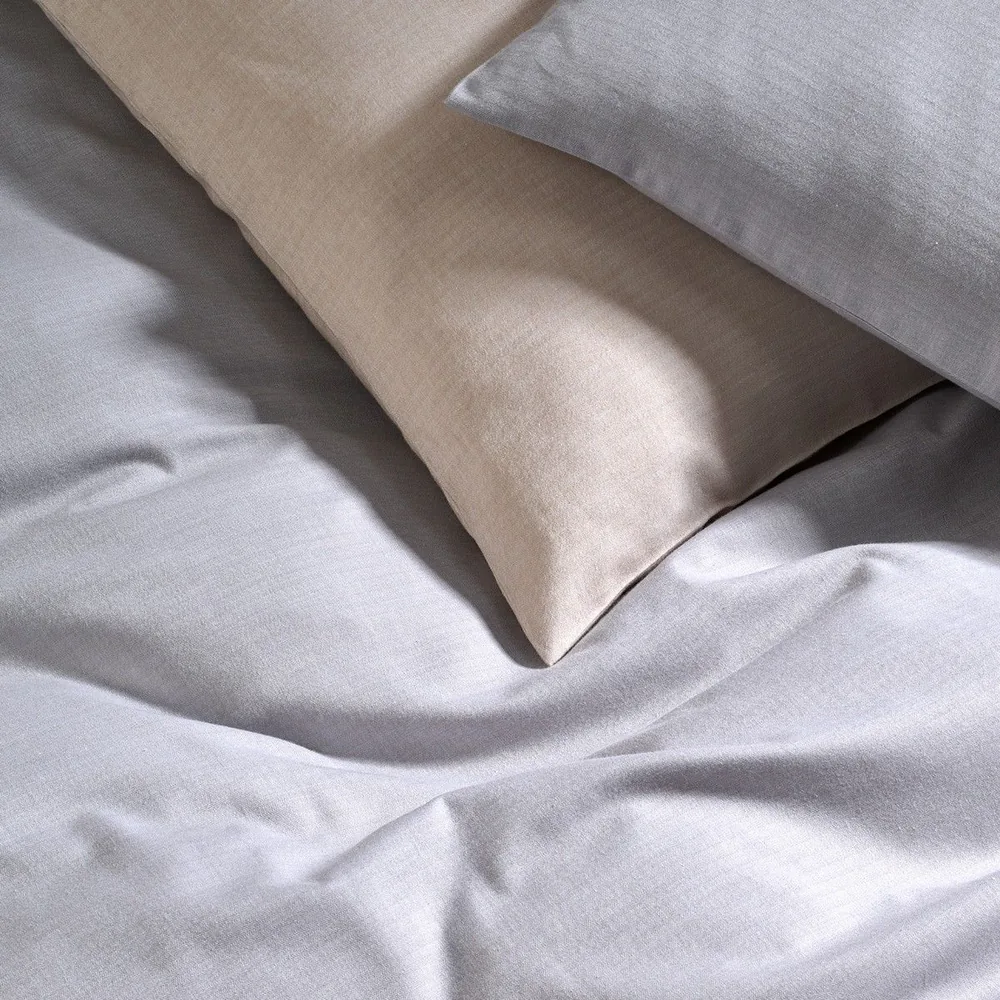 A close up of a bed with pillows on it
