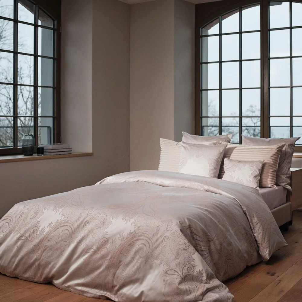 A close up of a bed with pillows on it