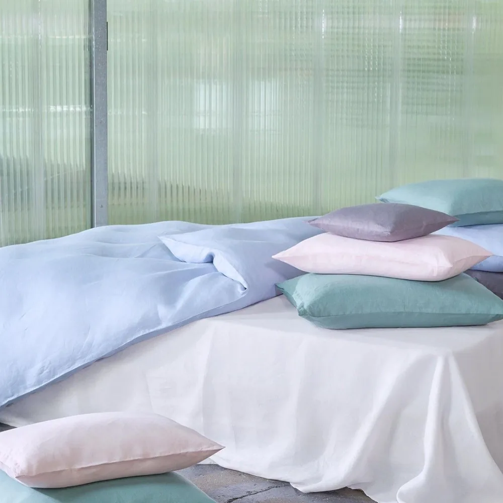 A bed with a lot of pillows on it