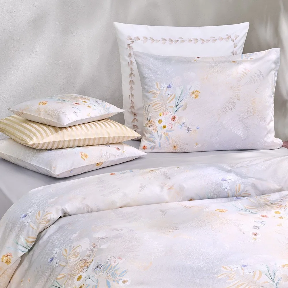 A close up of a bed with pillows on it