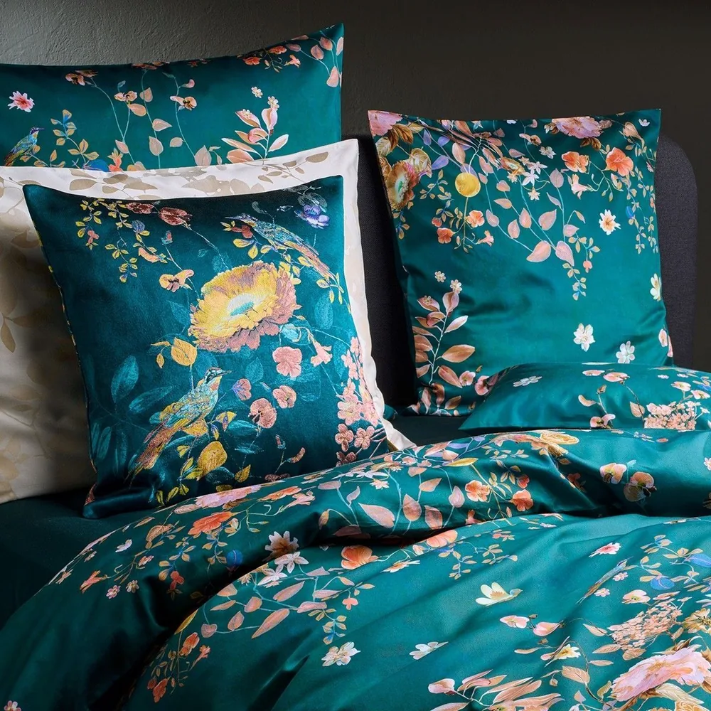 A close up of a bed with pillows on it