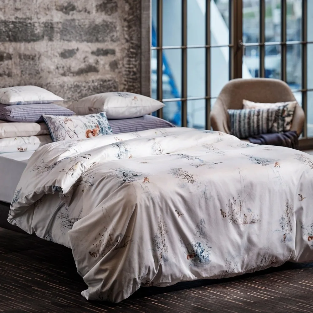 A close up of a bed with pillows on it