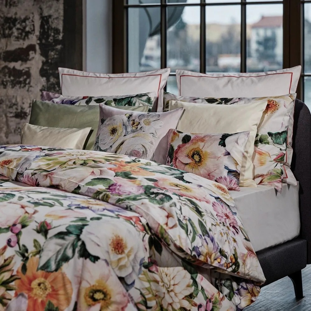 A close up of a bed with pillows on it
